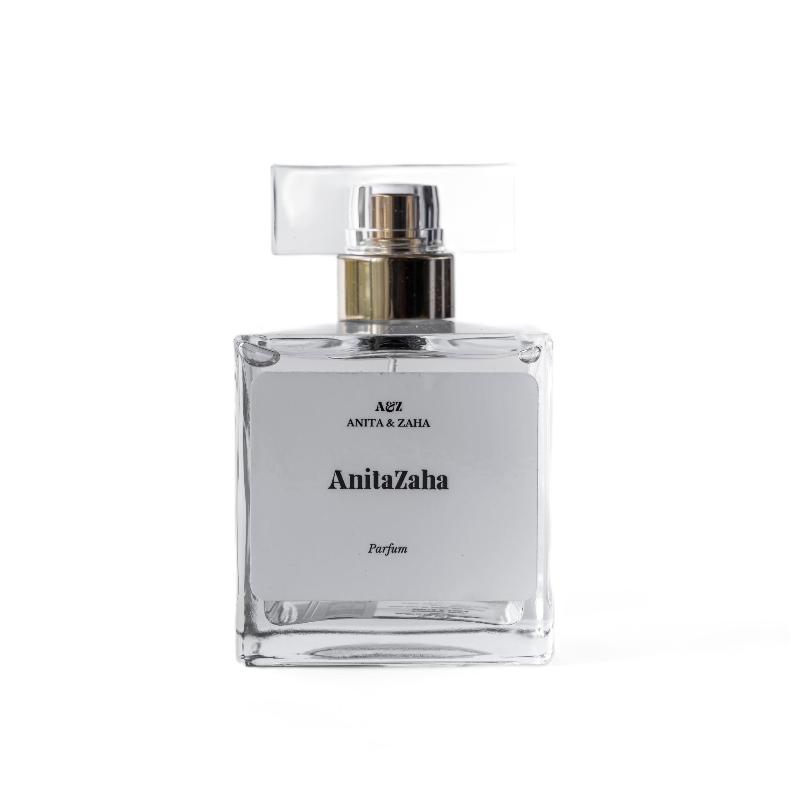 Flacon 100 ml du parfum ANITAZAHA en verre transparent, surmonté d’un capot clair, révélant une teinte dorée lumineuse et une esthétique minimaliste.